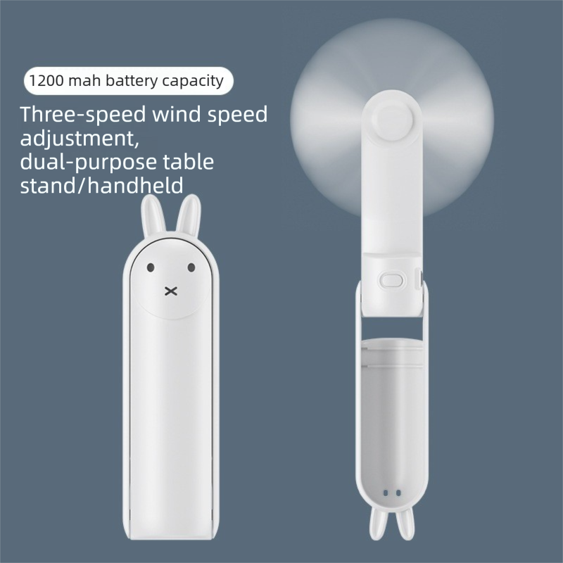 White Foldable Mini Handheld Fan—a portable, USB-rechargeable desktop fan featuring a cute rabbit design. It offers three speed settings, soft blades, and 270-degree rotation, with a built-in 1200mAh battery—ideal for travel, office use, and staying cool