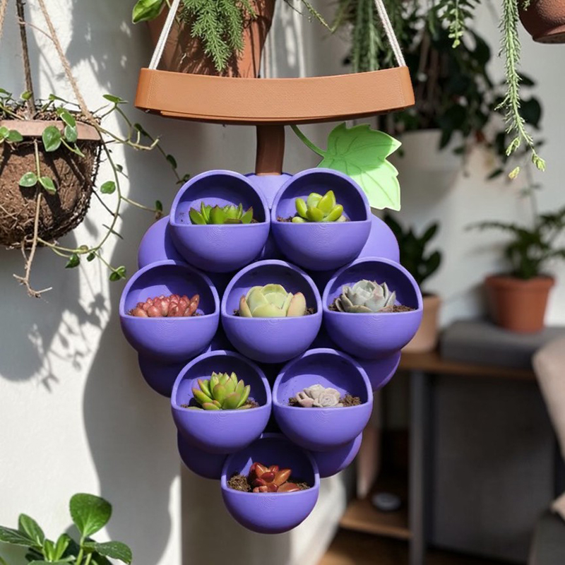 3D-printed grape pots in purple, brown, and green