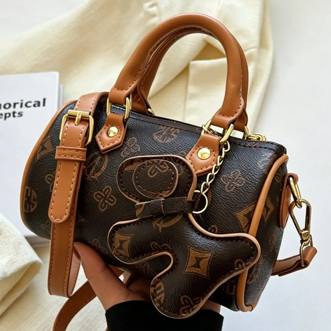 Classic Monogram Pillow Bag: Premium PU Leather with Luxe Feel, Cute Pet Charm for a Playful Touch, Compact Size Fits Phone, Multiple Carry Ways, Versatile for