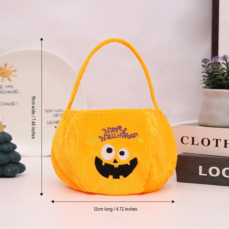 Yellow bag with a pumpkin pattern - Plush Halloween Trick or Treat Candy Bag - Polyester Tote with Embroidered Face, Lightweight Portable Goody Pouch — image 6