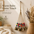 Handmade Bohemian Wind Chime, featuring jute rope with brass bells and colorful wooden beads, rings melodiously in the gentle breeze, adding natural romance to your home.