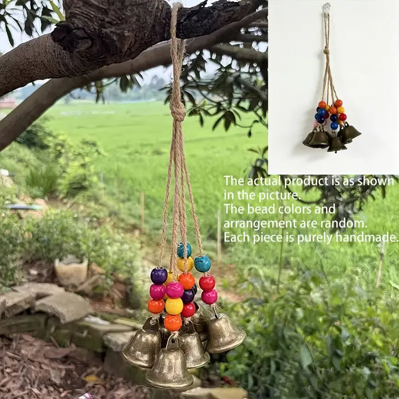 Handmade Bohemian Wind Chime, featuring jute rope with brass bells and colorful wooden beads, rings melodiously in the gentle breeze, adding natural romance to your home.